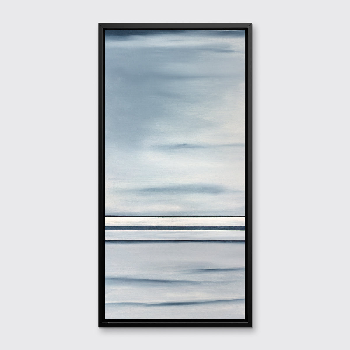 A blue and white geometric abstract print hangs in a black floater frame on a white wall.
