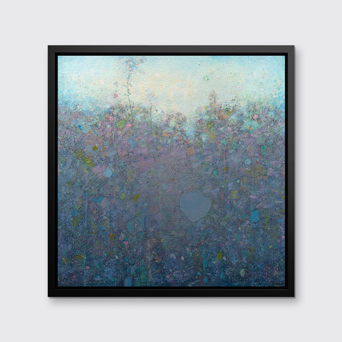 A dark purple and blue abstract landscape print in a black floater frame hangs on a white wall.
