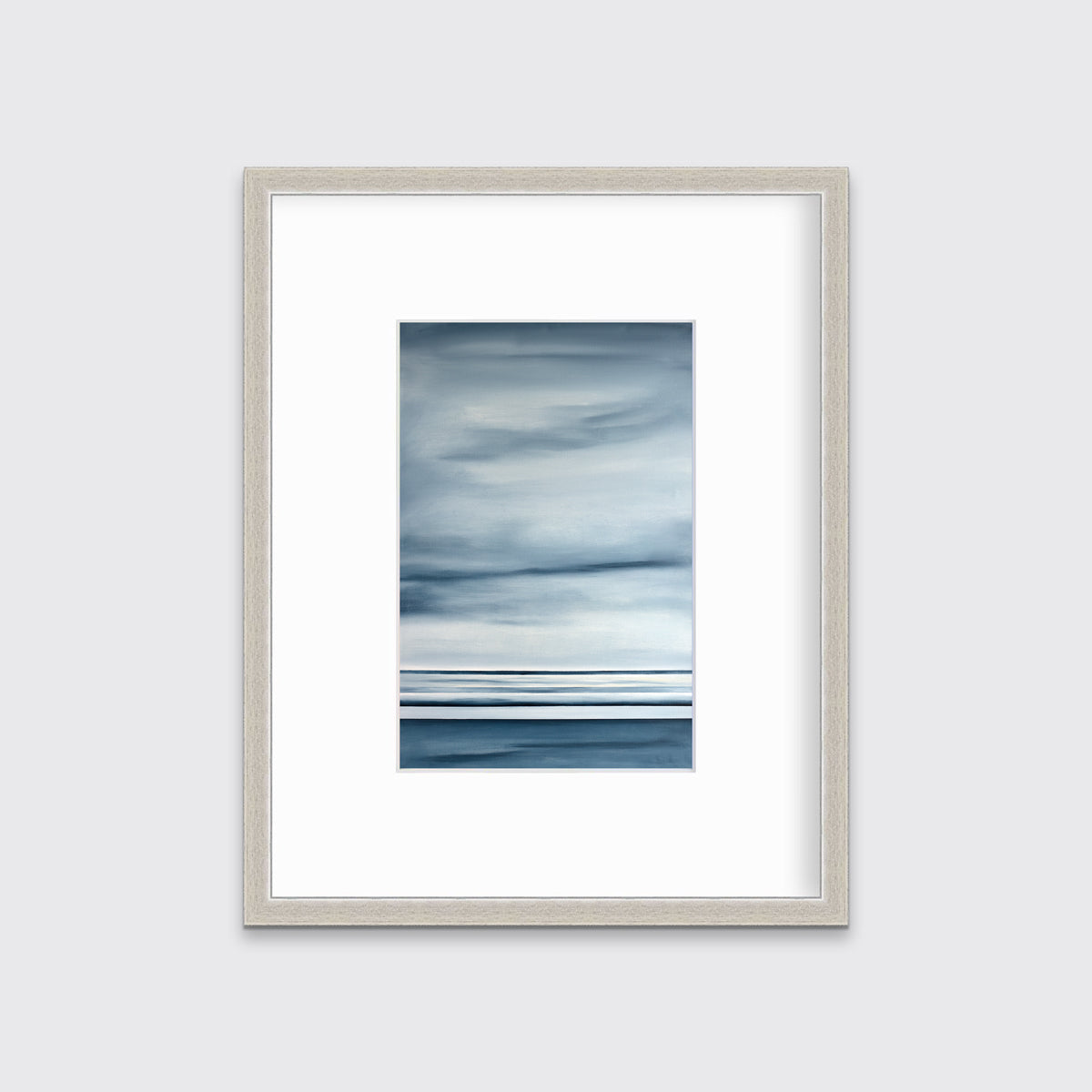 Blue and white linear abstract print in a silver frame with a mat on a white wall.