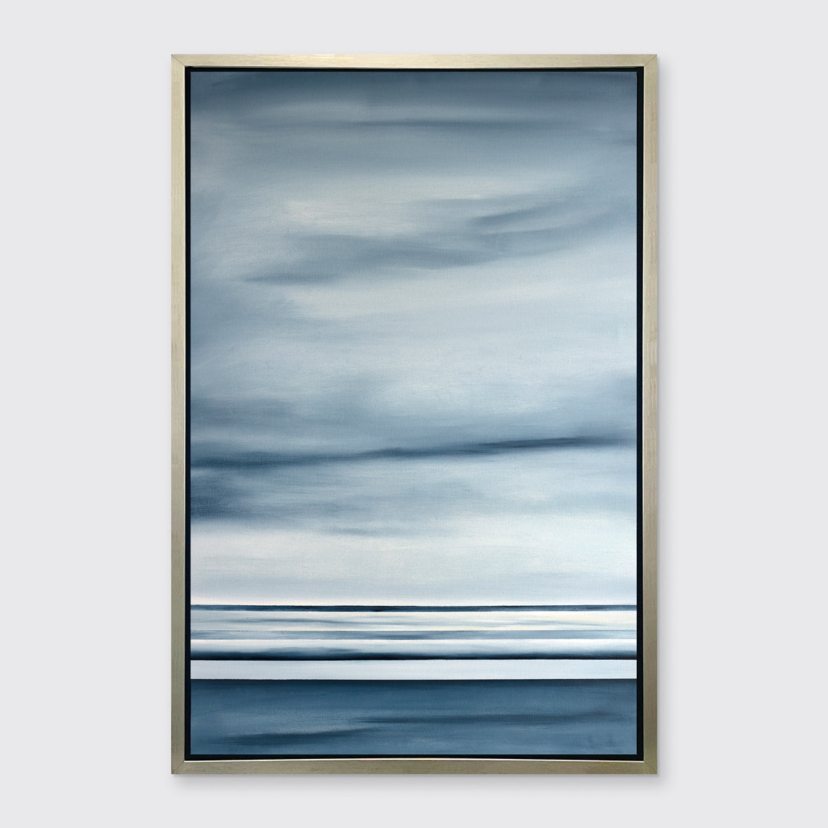 A blue and white linear abstract print in a silver floater frame on a white wall.