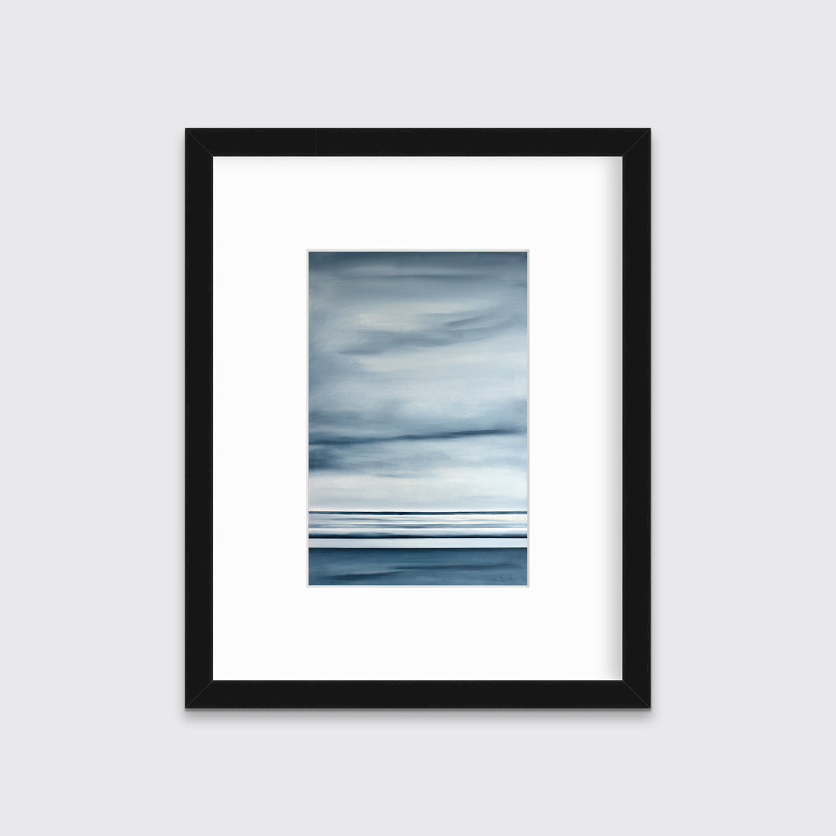 Blue-grey abstract print in a black frame with a mat hangs on a white wall.