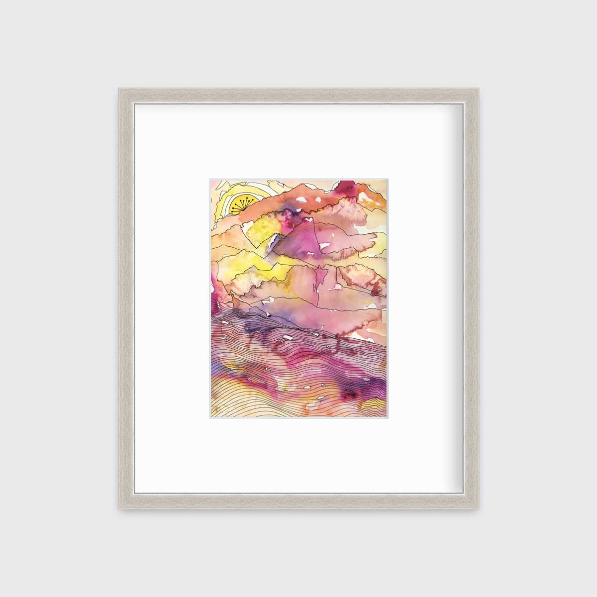A yellow, pink, orange and black abstract landscape print in a silver frame with a mat hangs on a white wall.