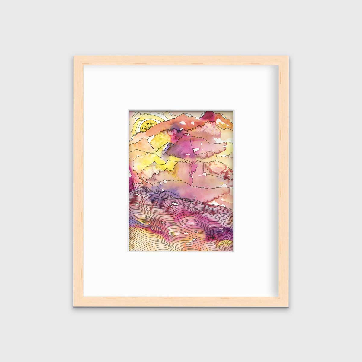 A yellow, pink, orange and black abstract landscape print in a natural wood frame with a mat hangs on a white wall.
