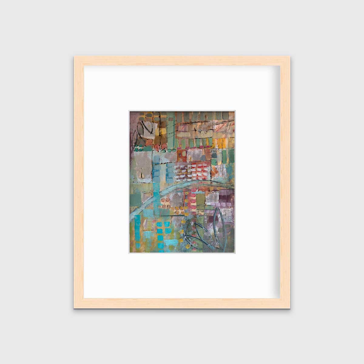 A multicolored abstract print in a natural wood frame with a mat hangs on a white wall.