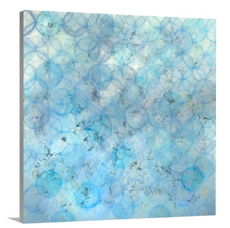 A side-angle view of a blue and silver abstract circle print on canvas.