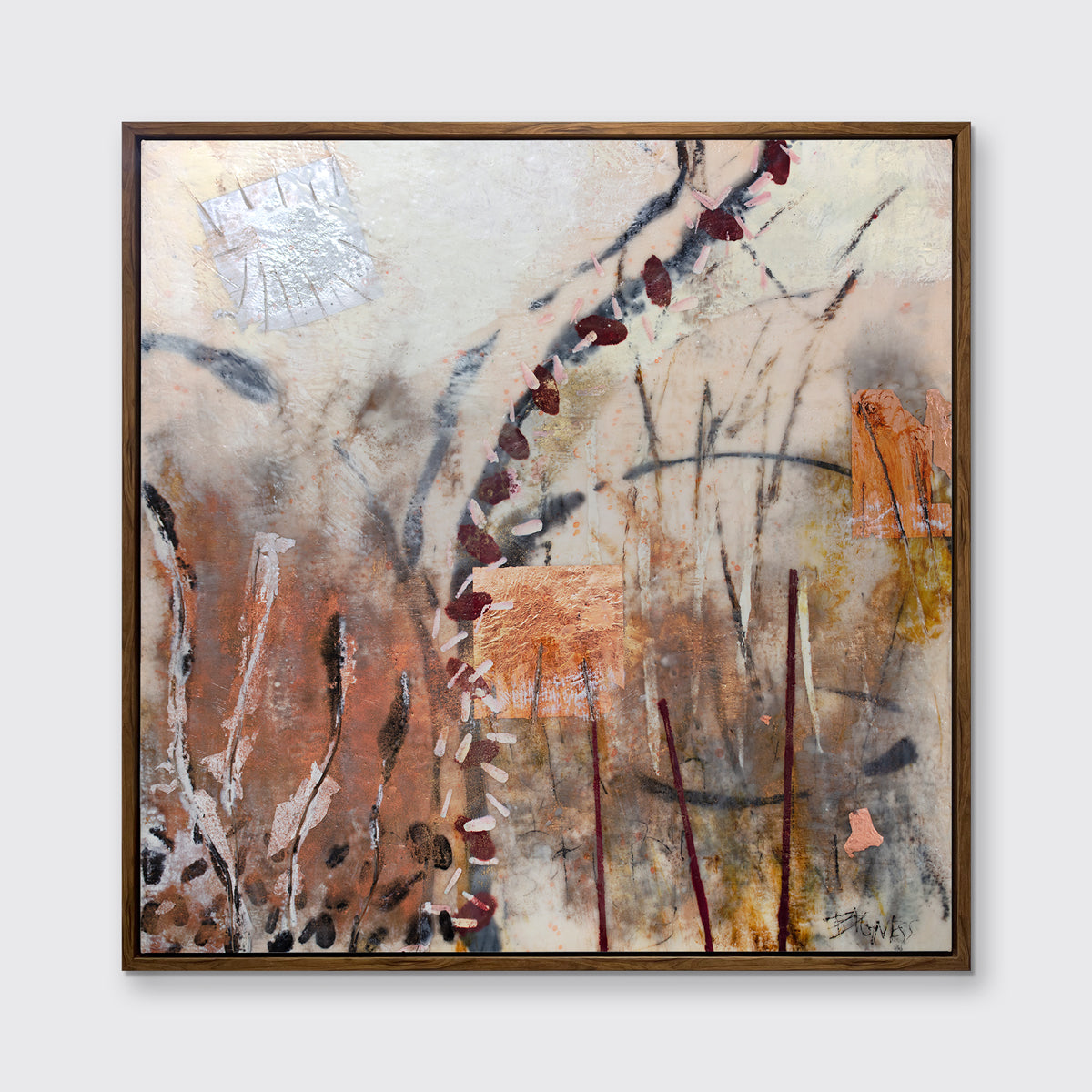 A beige, copper, gold and silver abstract print in an oak wood floater frame hangs on a white wall.