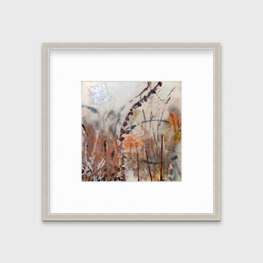 A brown, orange and gold abstract print in a silver frame with a mat hangs on a white wall.