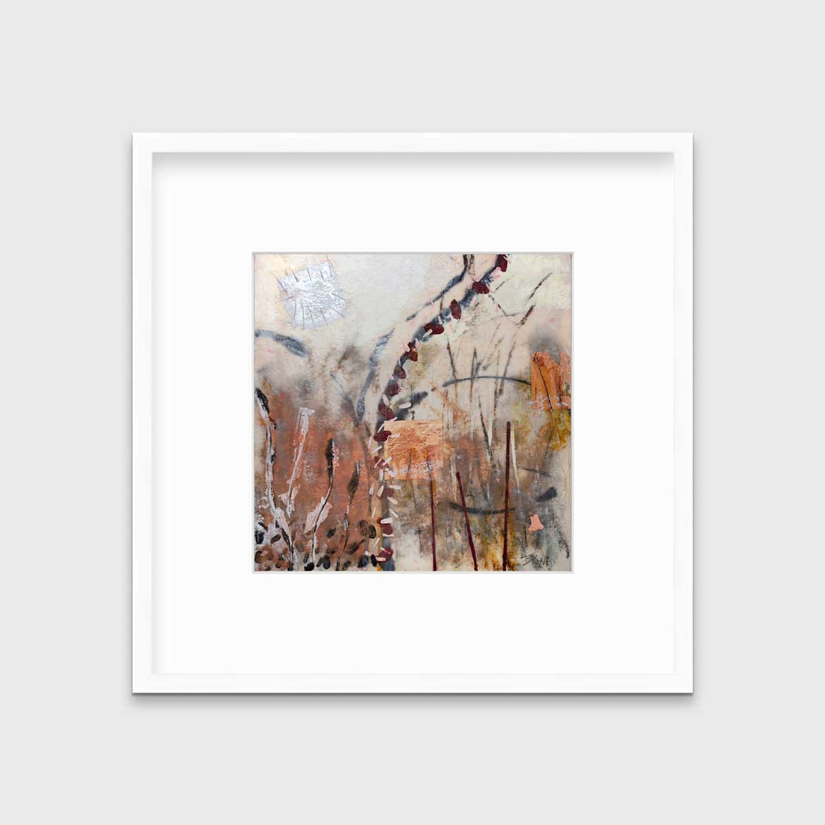 A brown, orange and gold abstract print in a white frame with a mat hangs on a white wall.