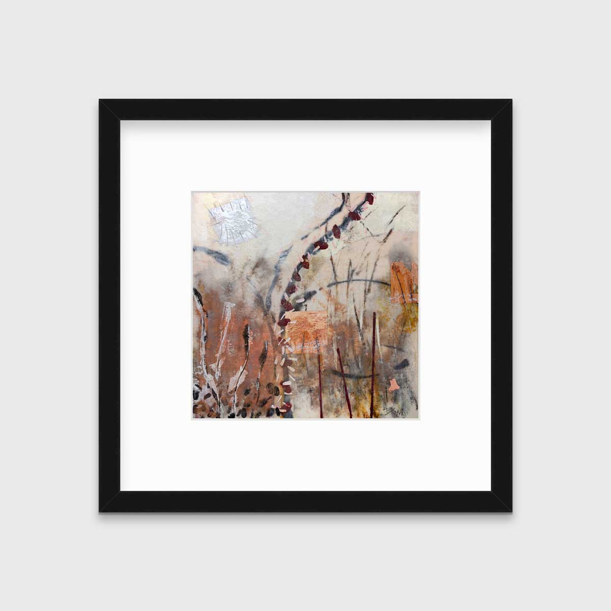 A brown, orange and gold abstract print in a black frame with a mat hangs on a white wall.