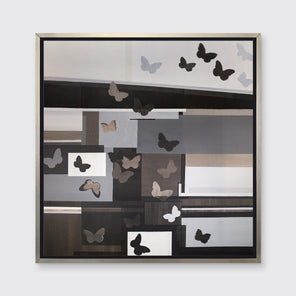 A black, white, and grey geometric print with butterflies in a silver floater frame hangs on a white wall.