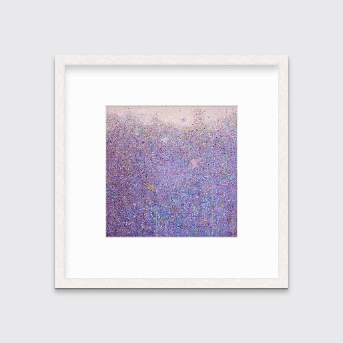 A pink abstract landscape in a whitewashed frame with a mat hangs on a white wall.