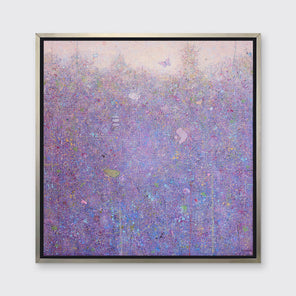 A pink abstract landscape with butterflies in a silver floater frame hangs on a white wall.