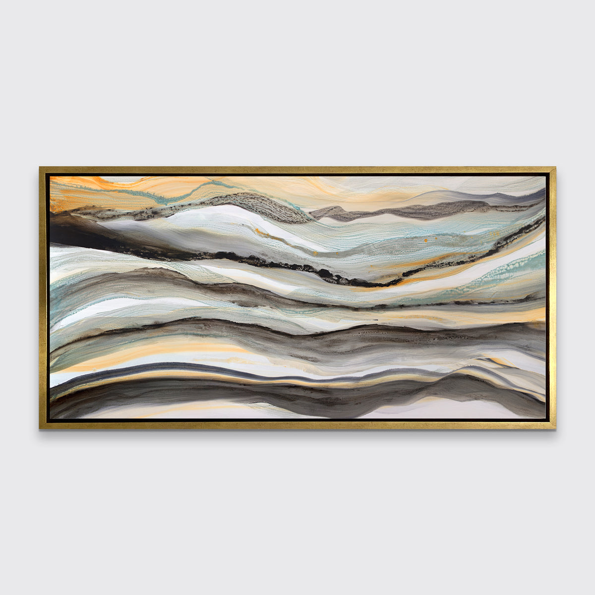 A black, white, orange and teal abstract print in a gold floater frame hangs on a white wall.