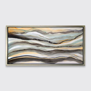 A black, white, orange and teal abstract print in a silver floater frame hangs on a white wall.