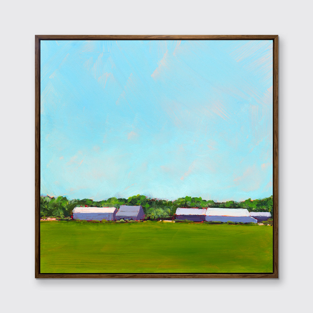 A blue, green, lavender and white landscape print in an oak wood floater frame hangs on a white wall.