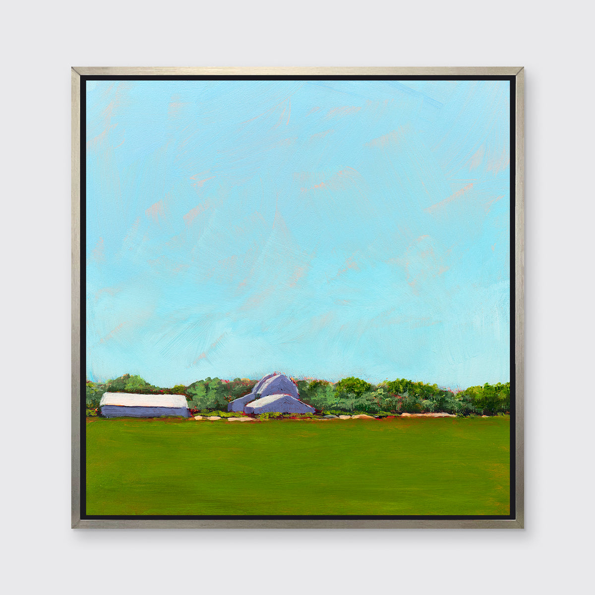 A blue, green, lavender and white landscape print in a silver floater frame hangs on a white wall.