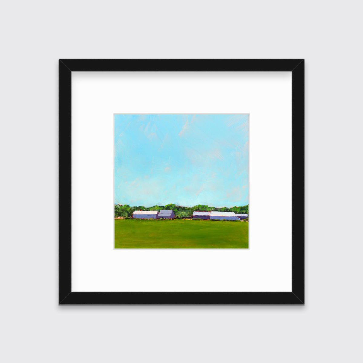 A blue, green, lavender and white landscape print in a black frame with a mat hangs on a white wall.