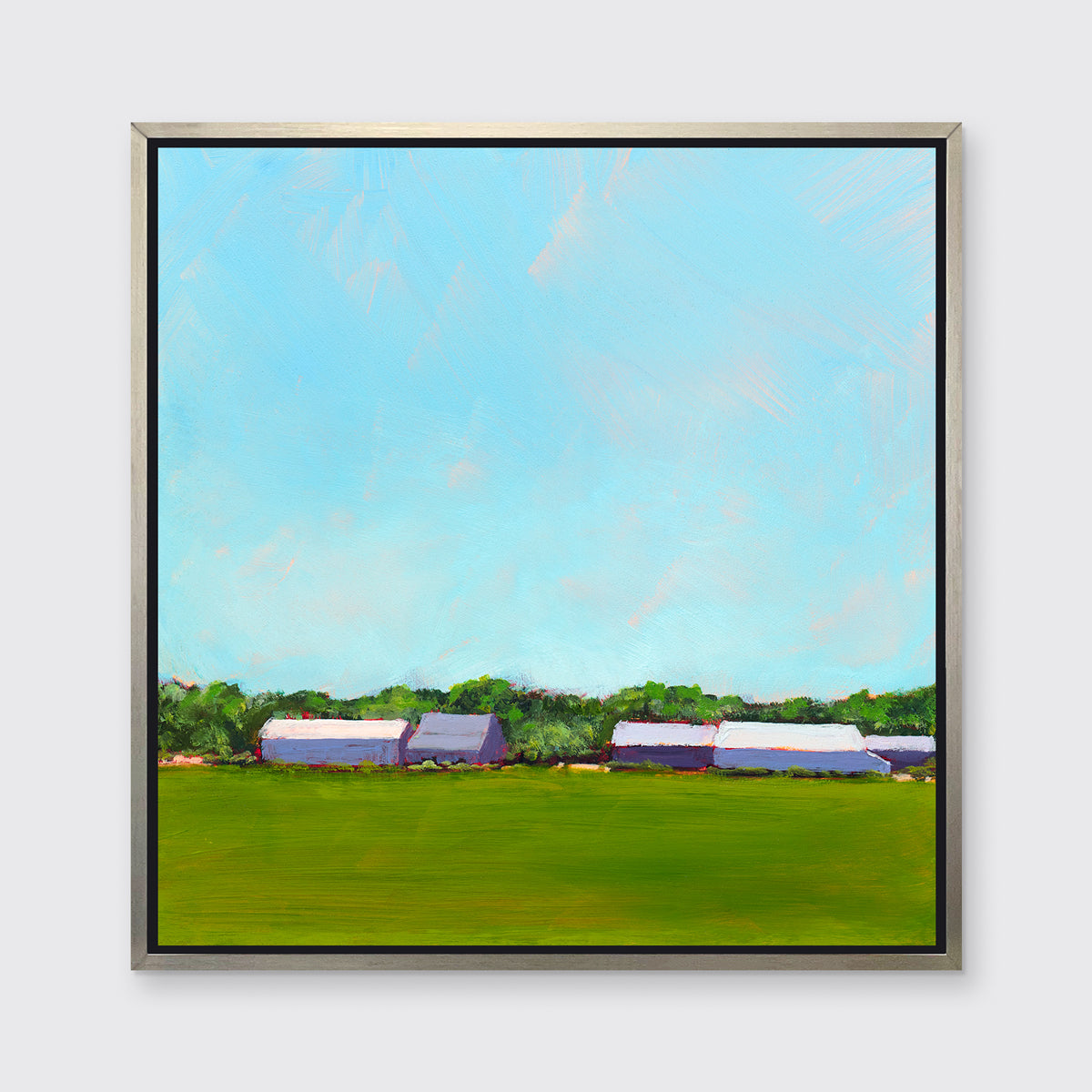 A blue, green, lavender and white landscape print in a silver floater frame hangs on a white wall.