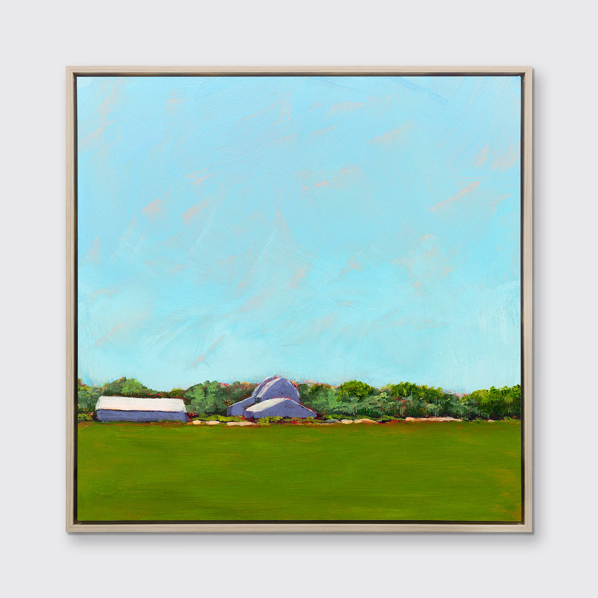 A blue, green, lavender and white landscape print in a white oak wood floater frame hangs on a white wall.