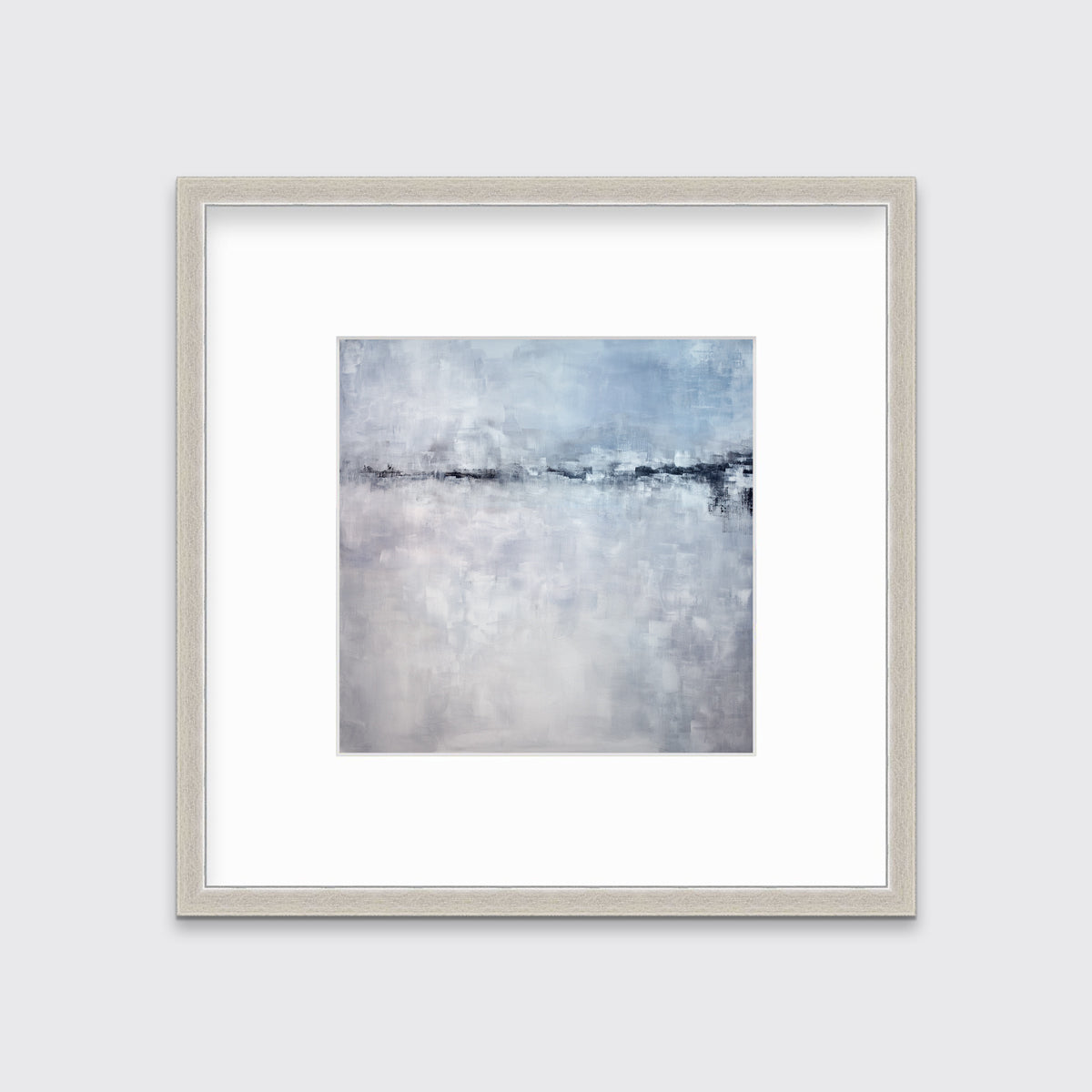 A blue and grey abstract print in a silver frame with a mat hangs on a white wall.
