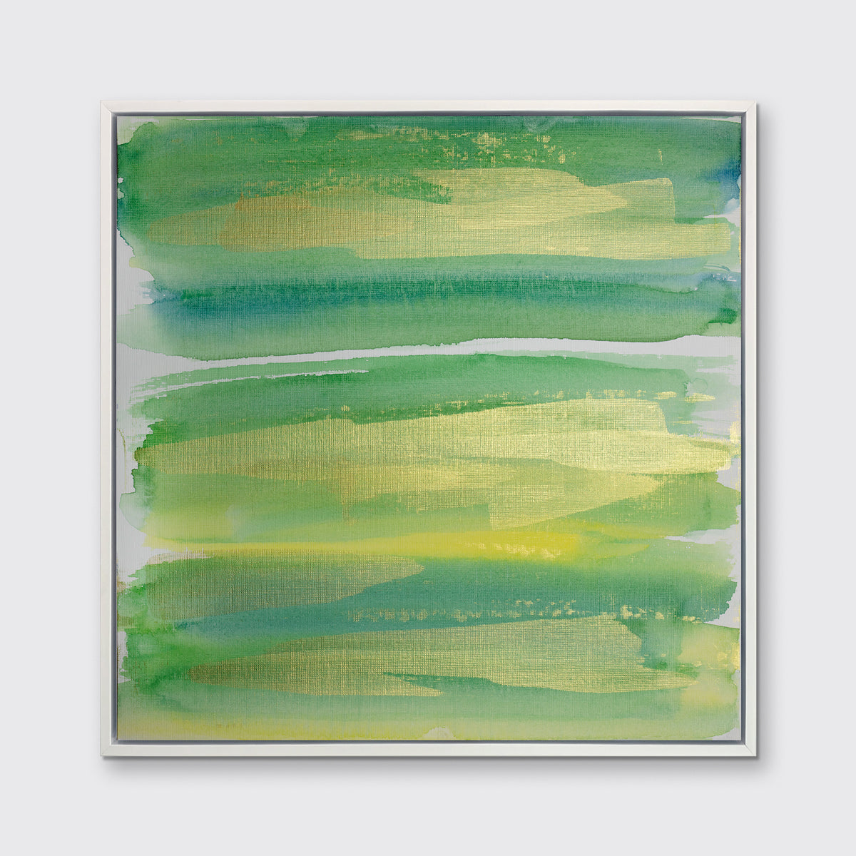 A green, blue and gold abstract print in a white floater frame hangs on a white wall.