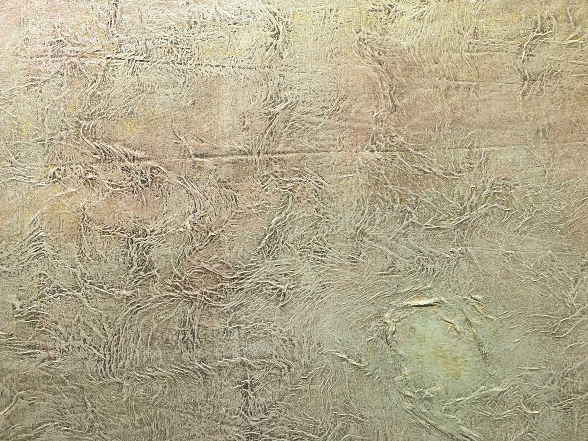 A slight close up view of the texture of the white and beige paint.
