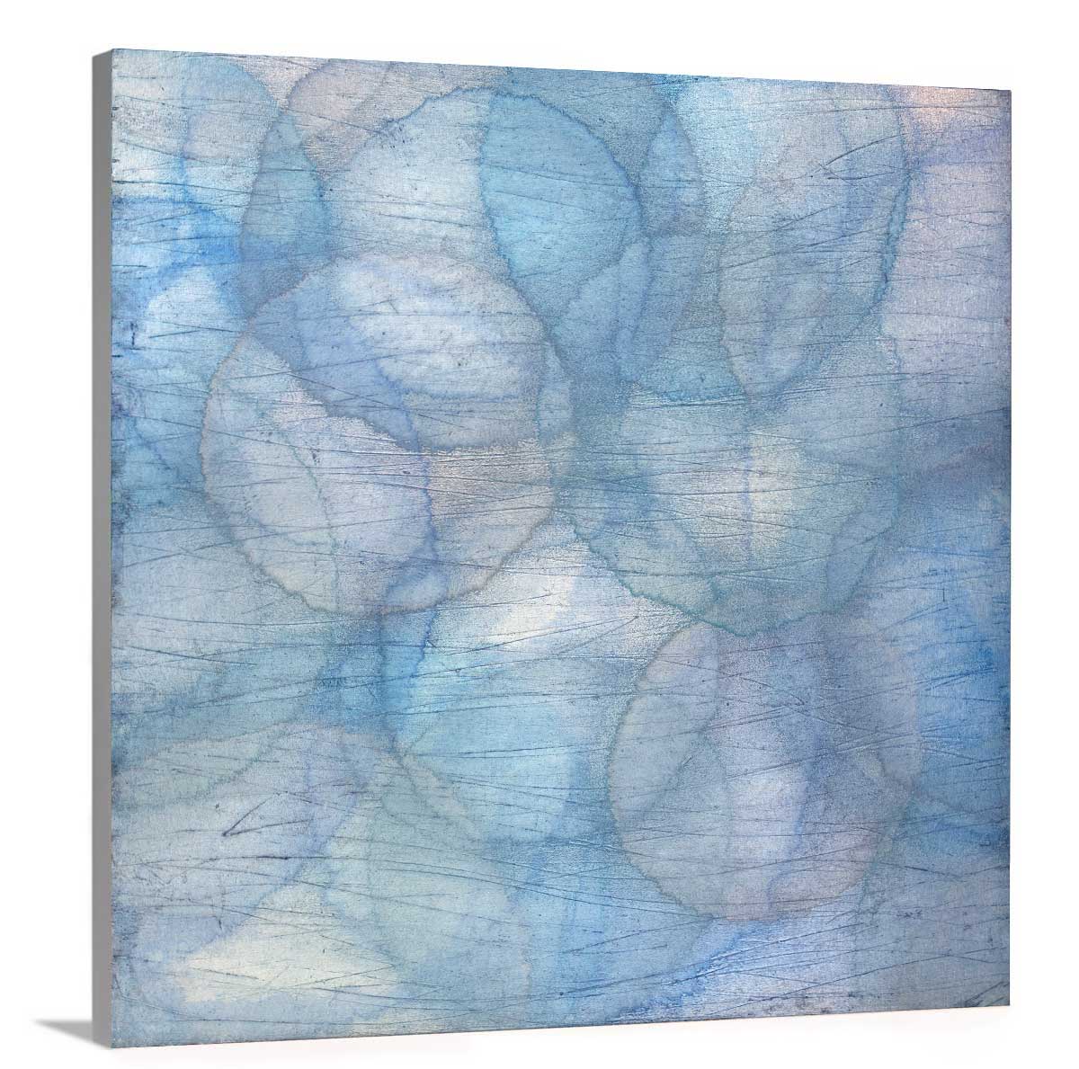 Layers of overlapping circles with an iridescent feel in blues, light purples and light greens staged on a side angle of a canvas.