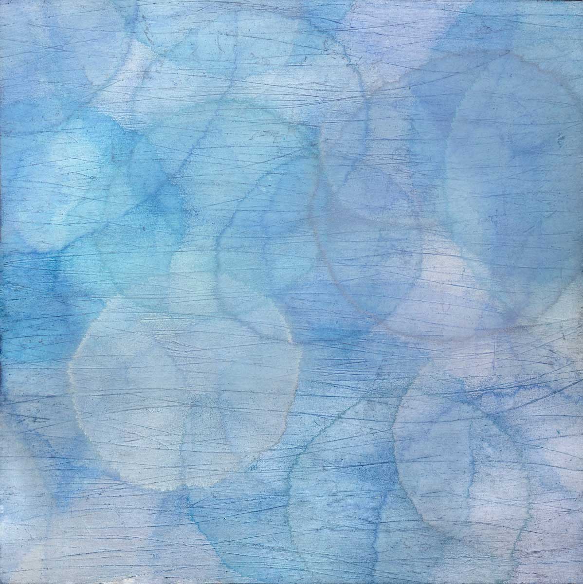 Layers of overlapping circles with an iridescent feel in blues, light purples and light greens.