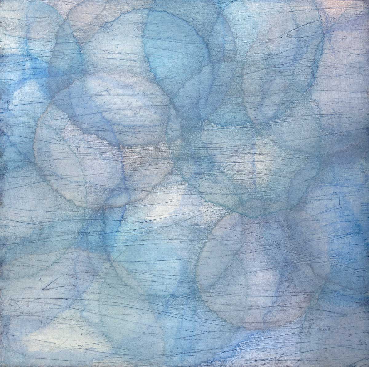 Layers of overlapping circles with an iridescent feel in blues, light purples and light greens.