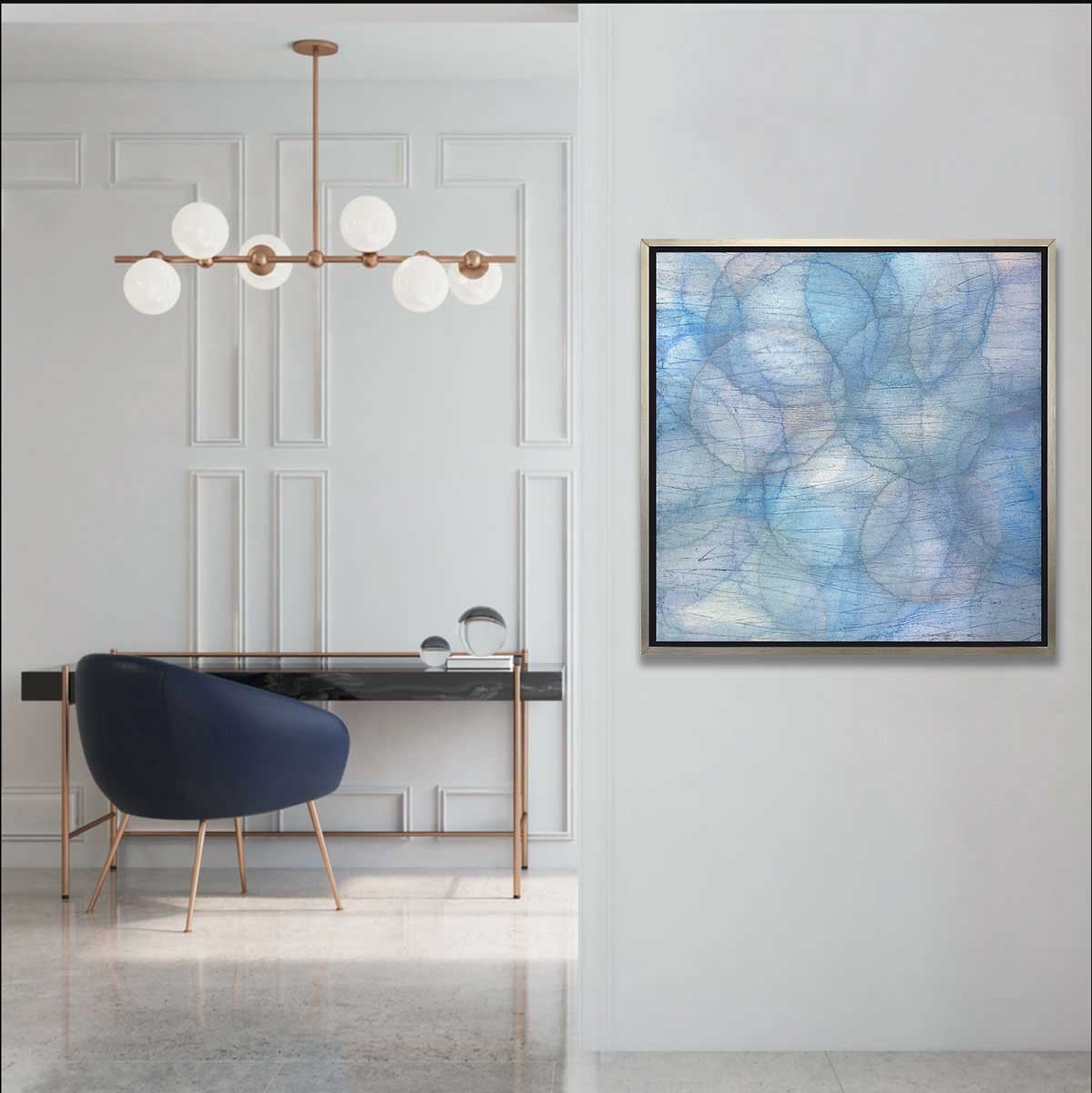 Layers of overlapping circles with an iridescent feel in blues, light purples and light greens staged in a silver floater frame on a hallway wall looking into a office.