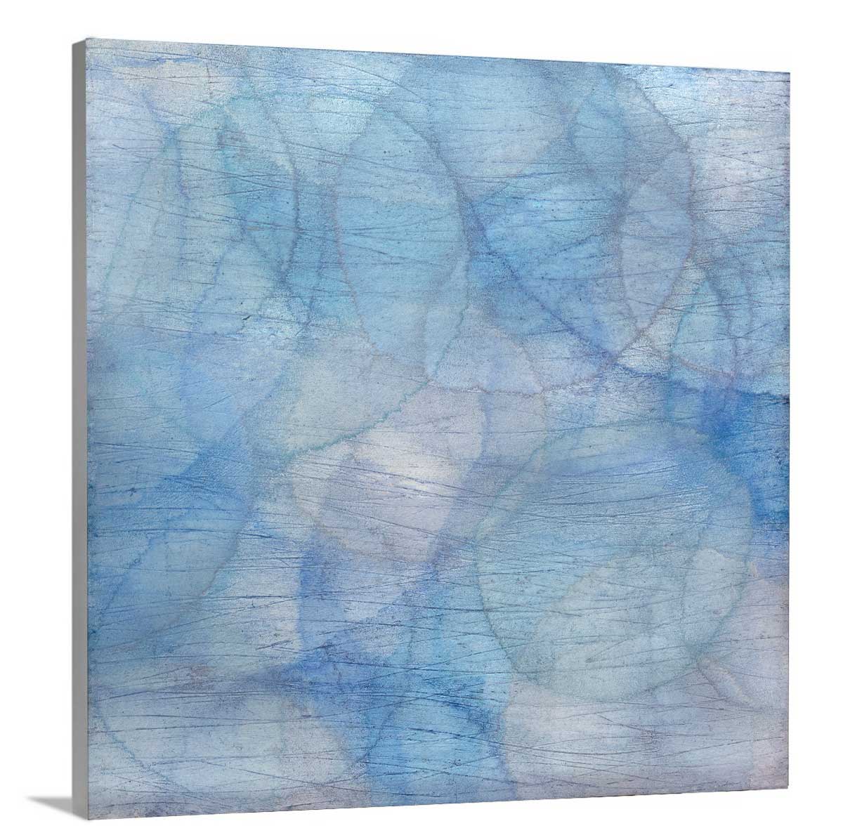 Layers of overlapping circles with an iridescent feel in blues, light purples and light greens staged on a side angle of a canvas.