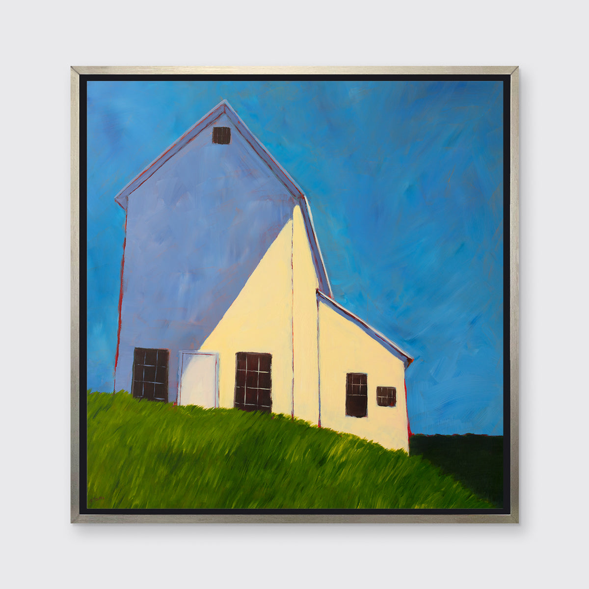 A blue, beige, lavender and green contemporary barn print in a silver floater frame hangs on a white wall.