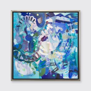 A blue, purple, green and white abstract print in a silver floater frame hangs on a white wall.