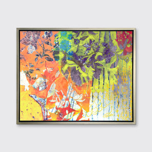 A multicolor abstract print in a silver floater frame hangs on a white wall.