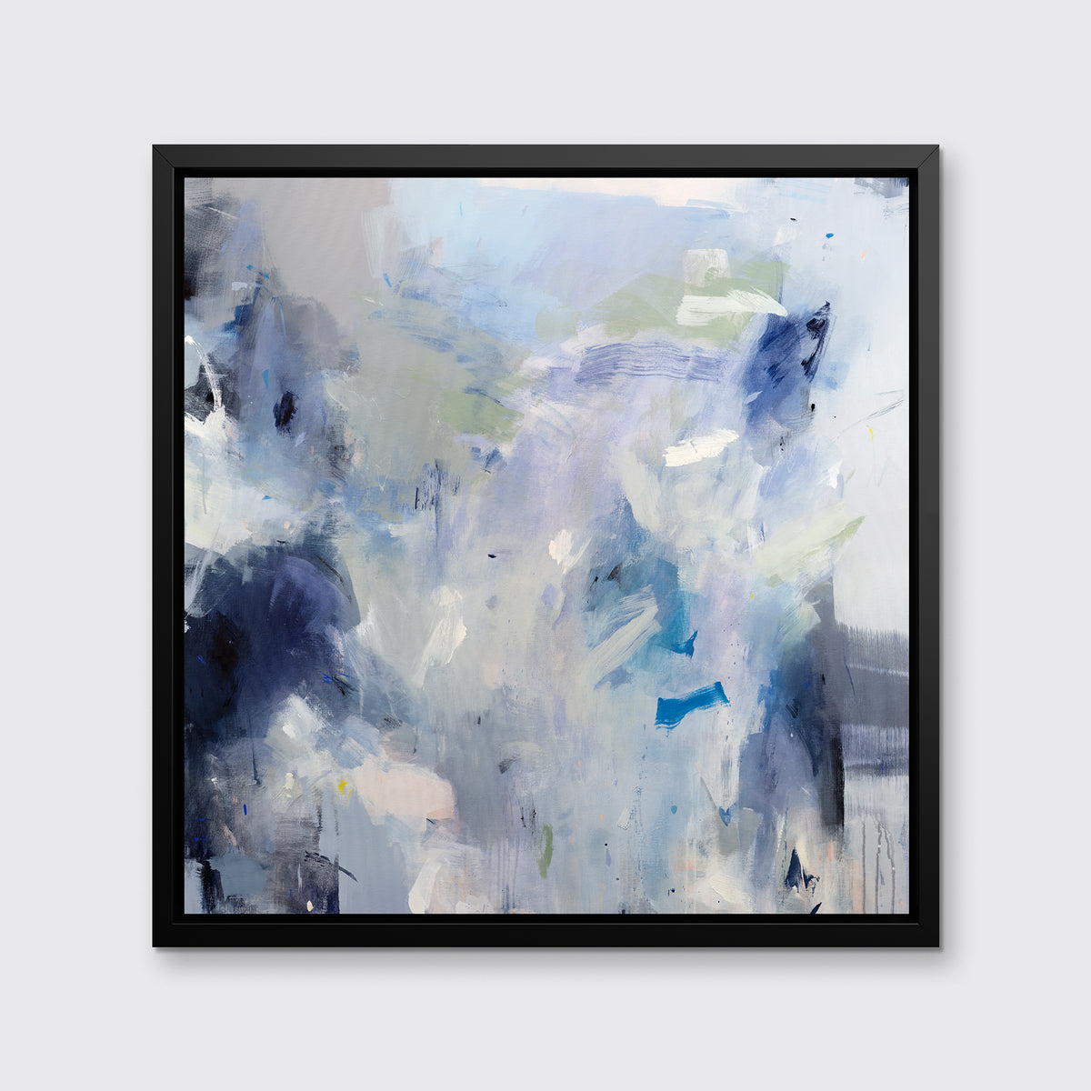 A blue, white, lavender and dark blue abstract print in a black floater frame hangs on a white wall.