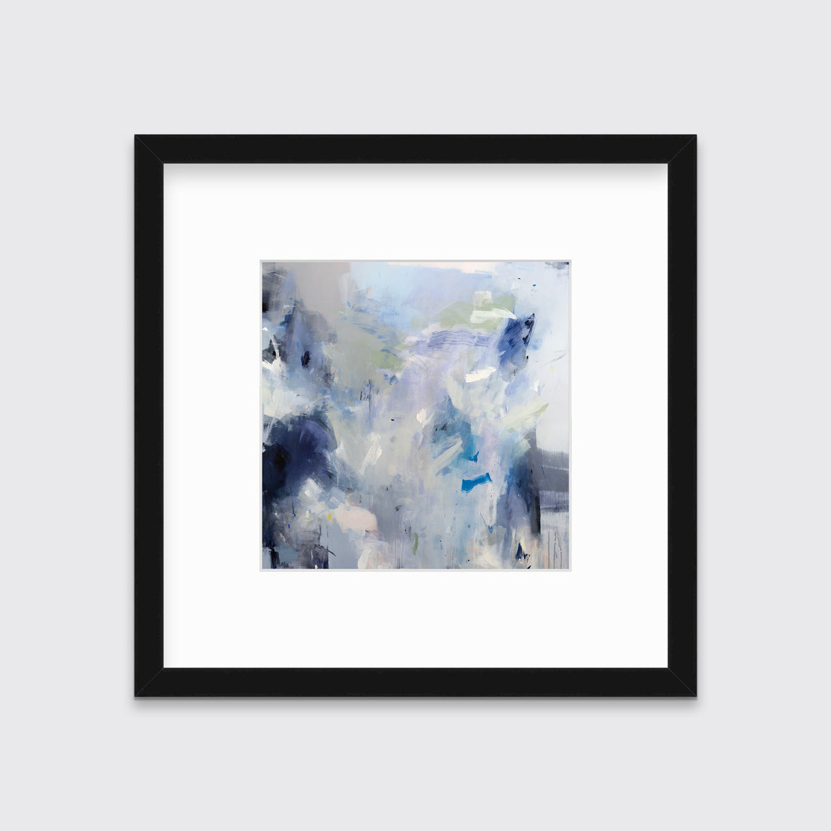 A blue, white, lavender and dark blue abstract print in a black frame with a mat hangs on a white wall.