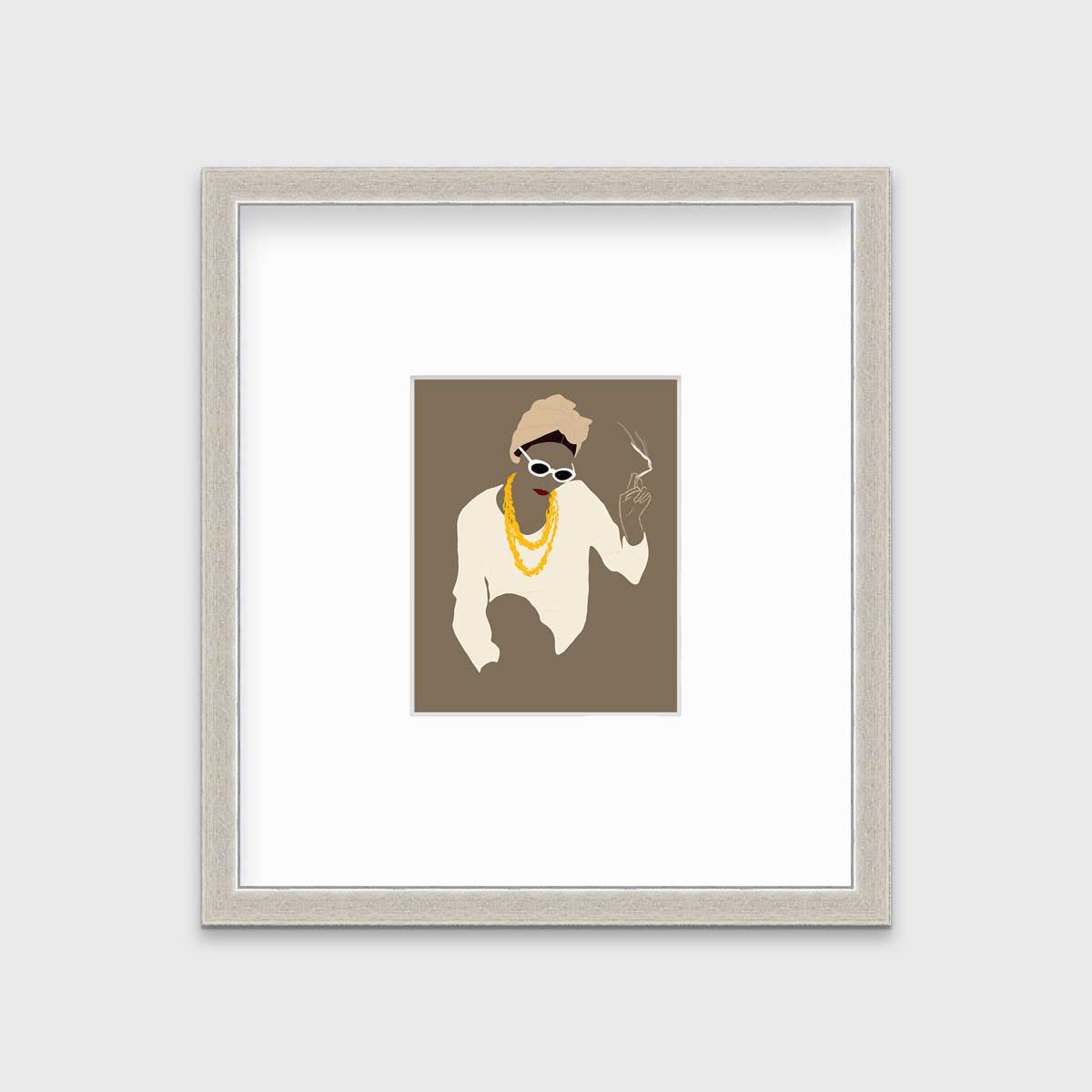 Pop art print of a woman holding a lite cigarette hangs in a silver frame with a mat on a white wall.