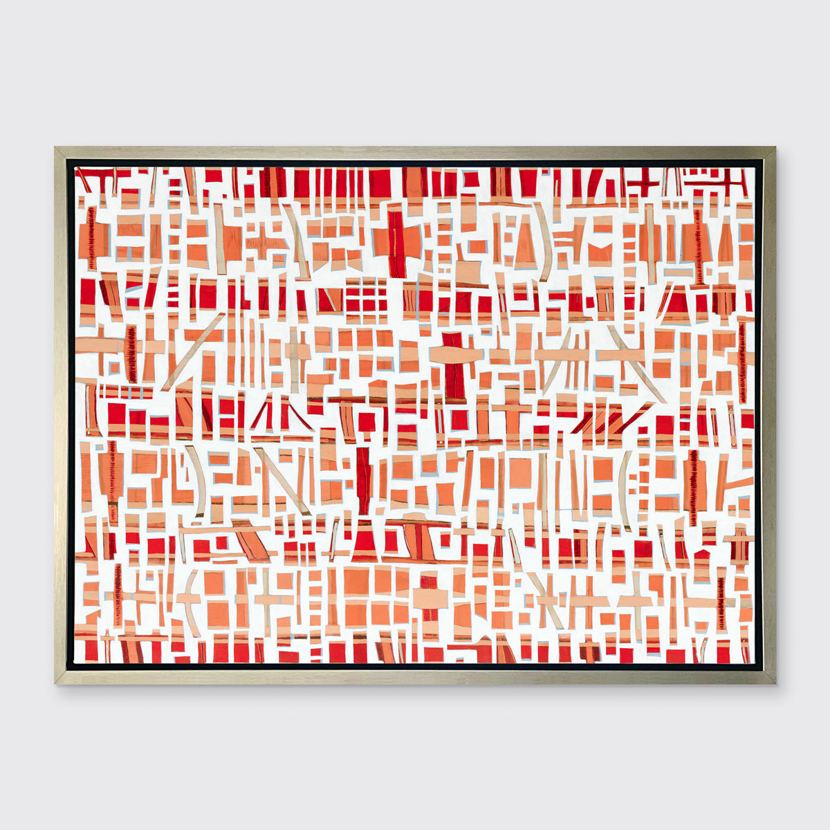 A red, white and orange abstract print in a silver floater frame hangs on a white wall.