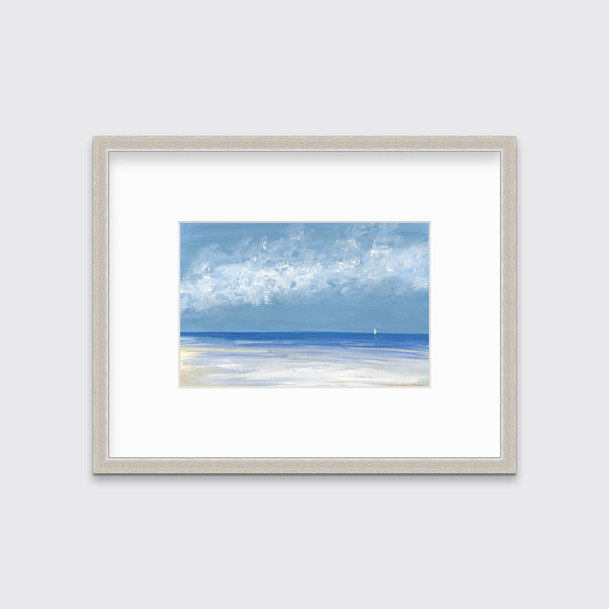 A blue, white and light blue abstract seascape in a silver frame with a mat hangs on a white wall.