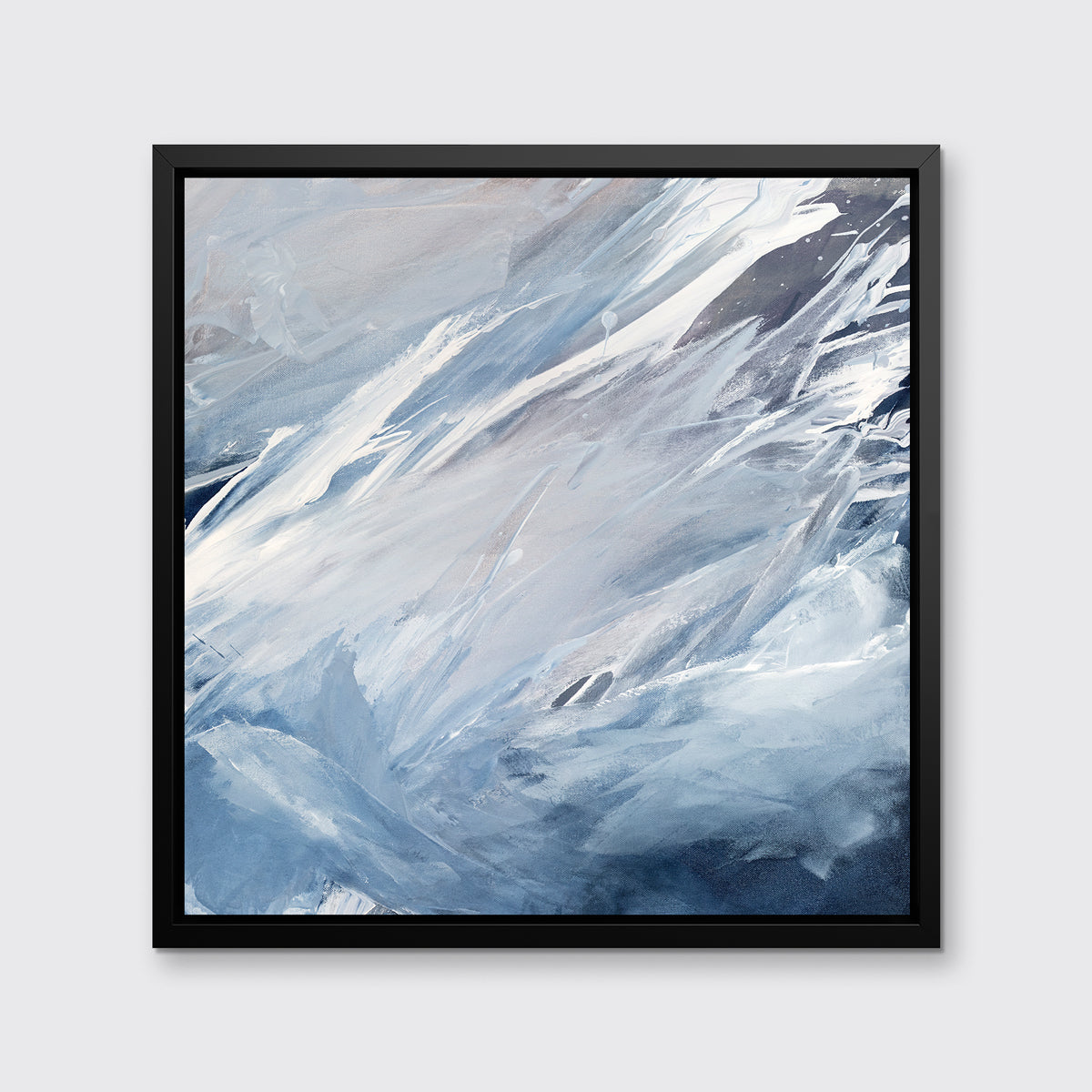 A blue, grey, white and charcoal abstract print in a black floater frame hangs on a white wall.