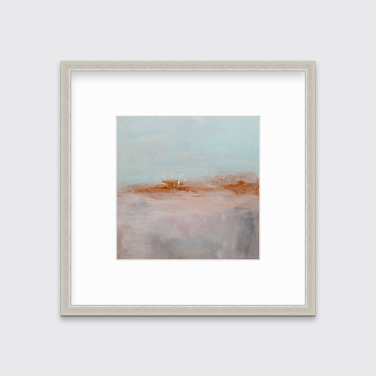 A teal, copper and dusty pink abstract print in a silver frame with a mat hangs on a white wall.