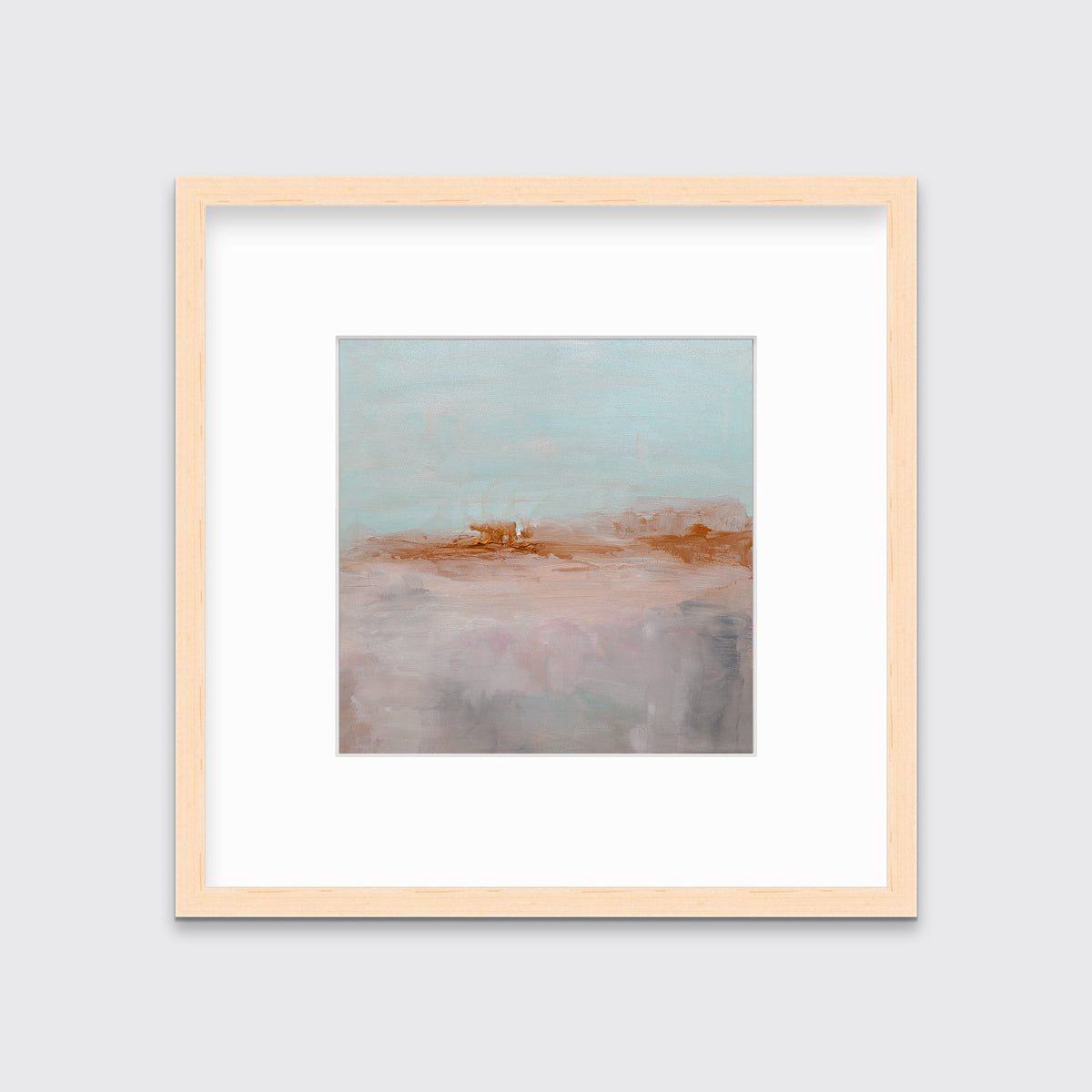 A teal, copper and dusty pink abstract print in a natural wood frame with a mat hangs on a white wall.