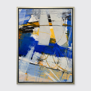 A blue, grey and yellow abstract print in a silver floater frame hangs on a white wall.