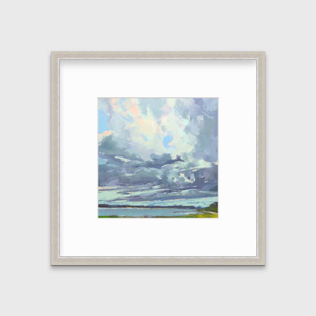 A blue, white and green abstract landscape print in a silver frame with a mat hangs on a white wall.