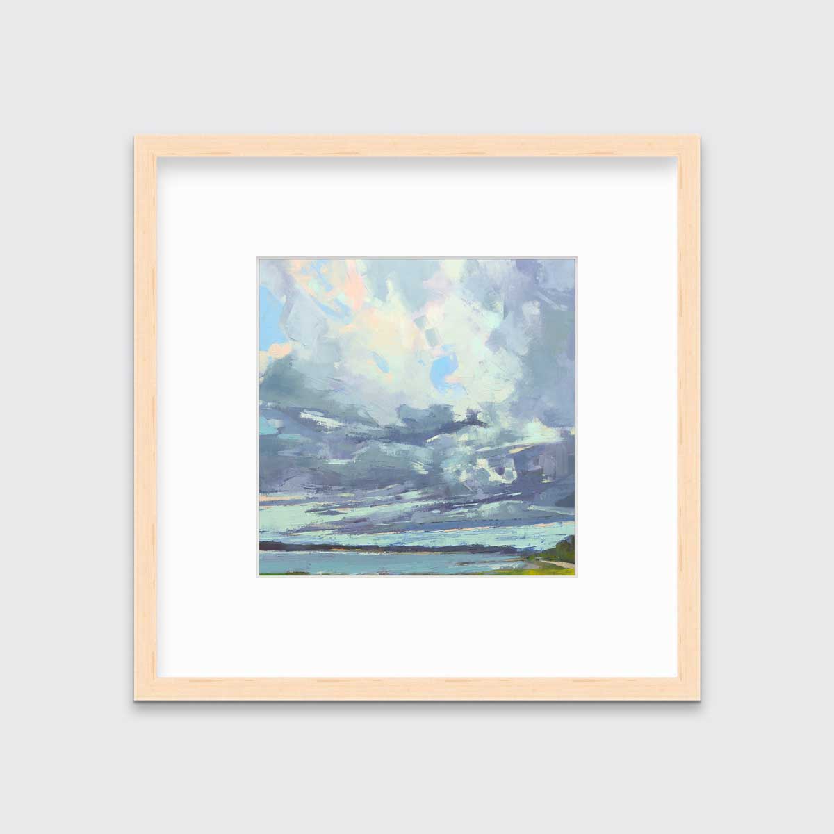 A blue, white and green abstract landscape print in a natural wood frame with a mat hangs on a white wall.