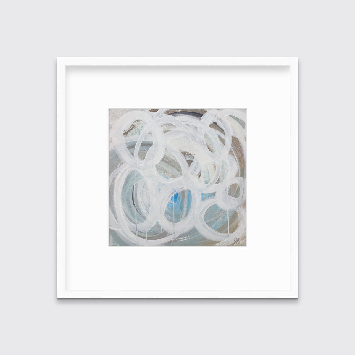 A white, light teal, blue and beige abstract print in a white frame with a mat hangs on a white wall.