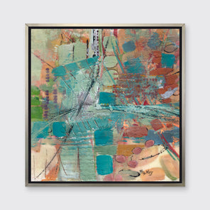 An abstract multicolored print staged in a silver floater frame on a light grey wall.