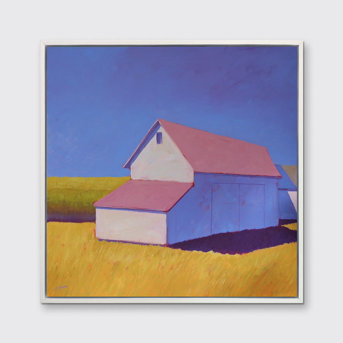 A white barn with a pink roof and yellow grass print in a white floater frame hangs on a white wall.
