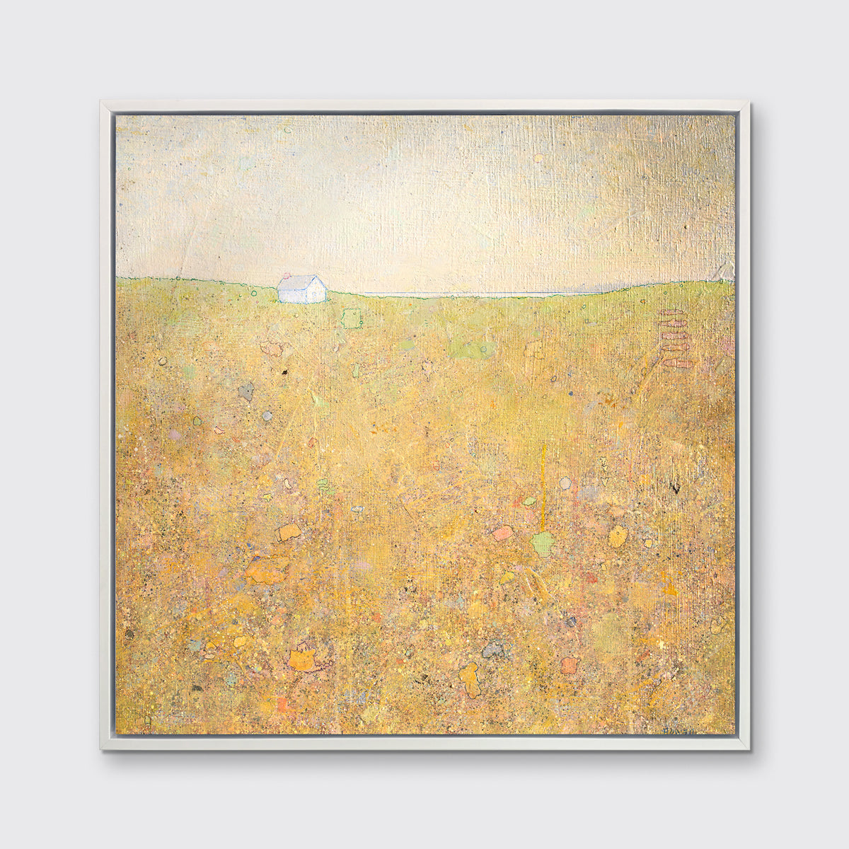 A yellow and grey abstract landscape print by Elwood Howell in a white floater frame hangs on a white wall.