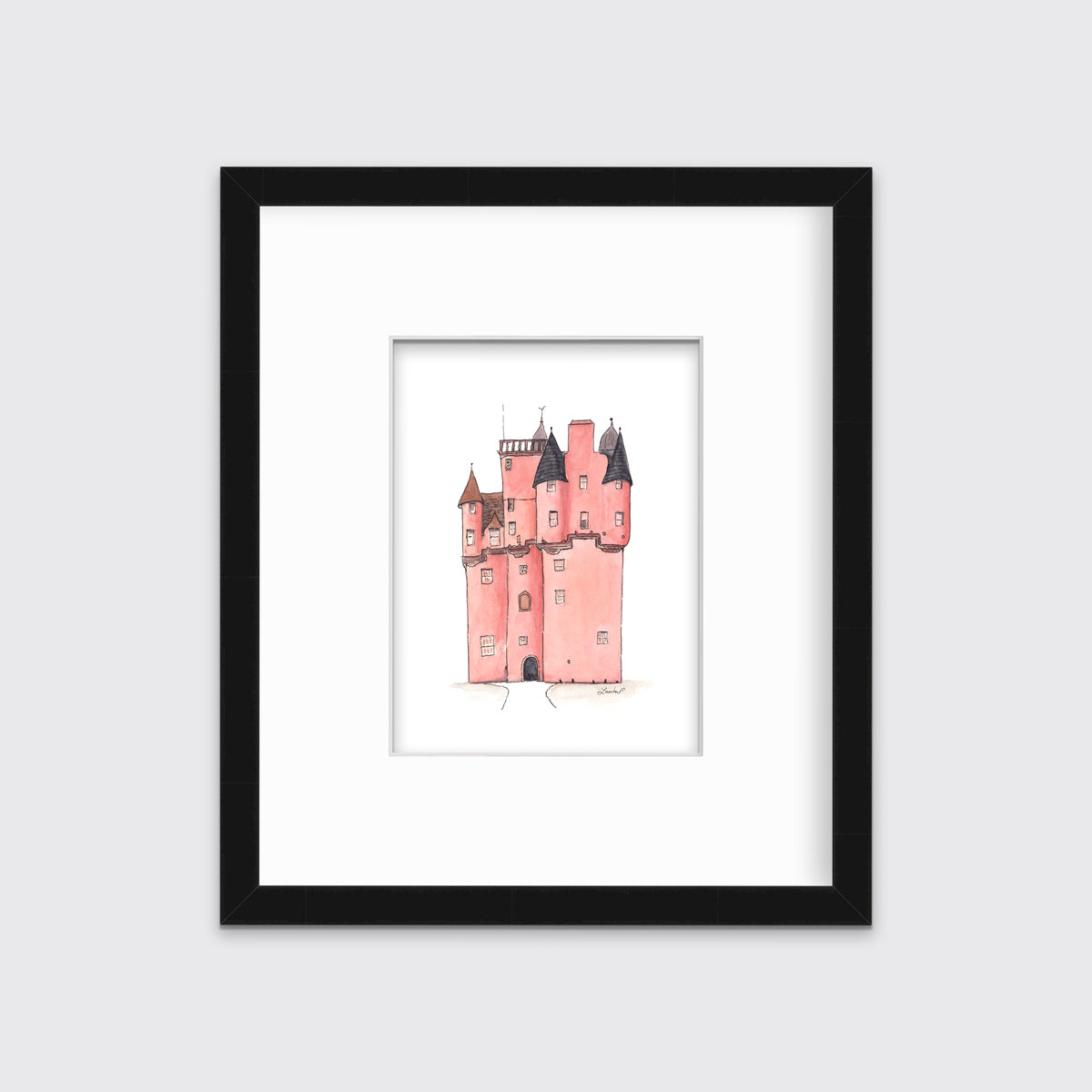 A pink and grey castle print in a black frame with a mat hangs on a white wall.